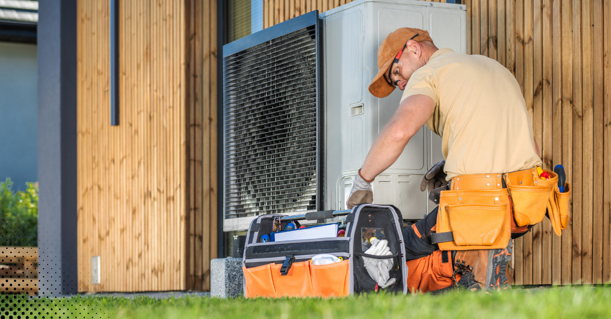 Inspector checking the interior components of a wall-mounted mini-split air conditioning unit.