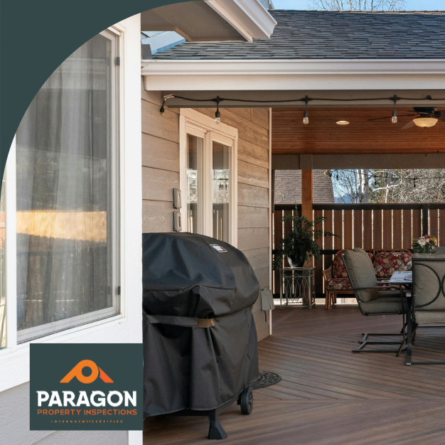 Spacious backyard deck with a covered seating area, ceiling fans, and a barbecue grill.