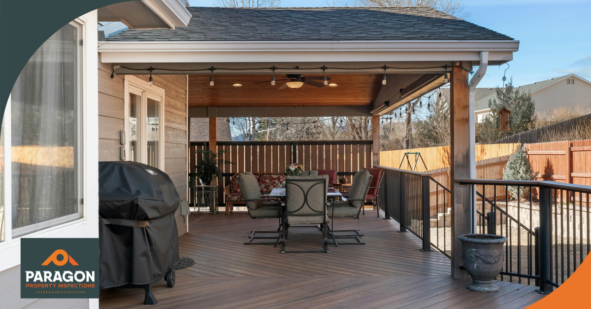 Spacious backyard deck with a covered seating area, ceiling fans, and a barbecue grill.