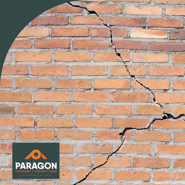 Cracked brick wall showing visible gaps and damage.