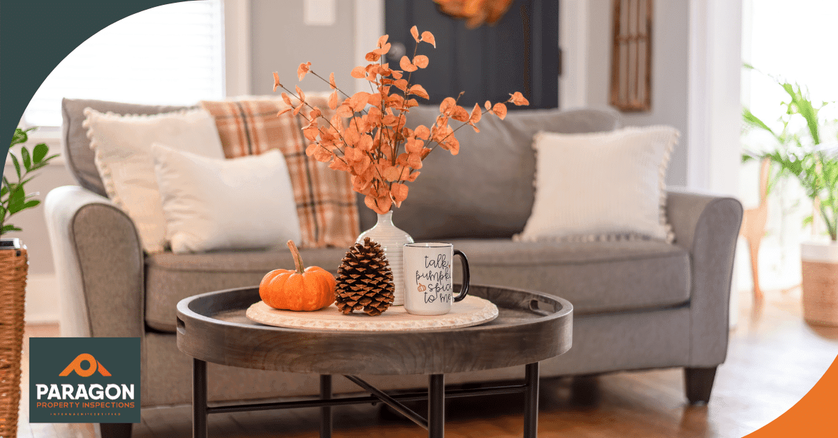 Fall-themed coffee table with a pumpkin, pinecone, autumn leaves, and a "Talk Pumpkin to Me" mug.
